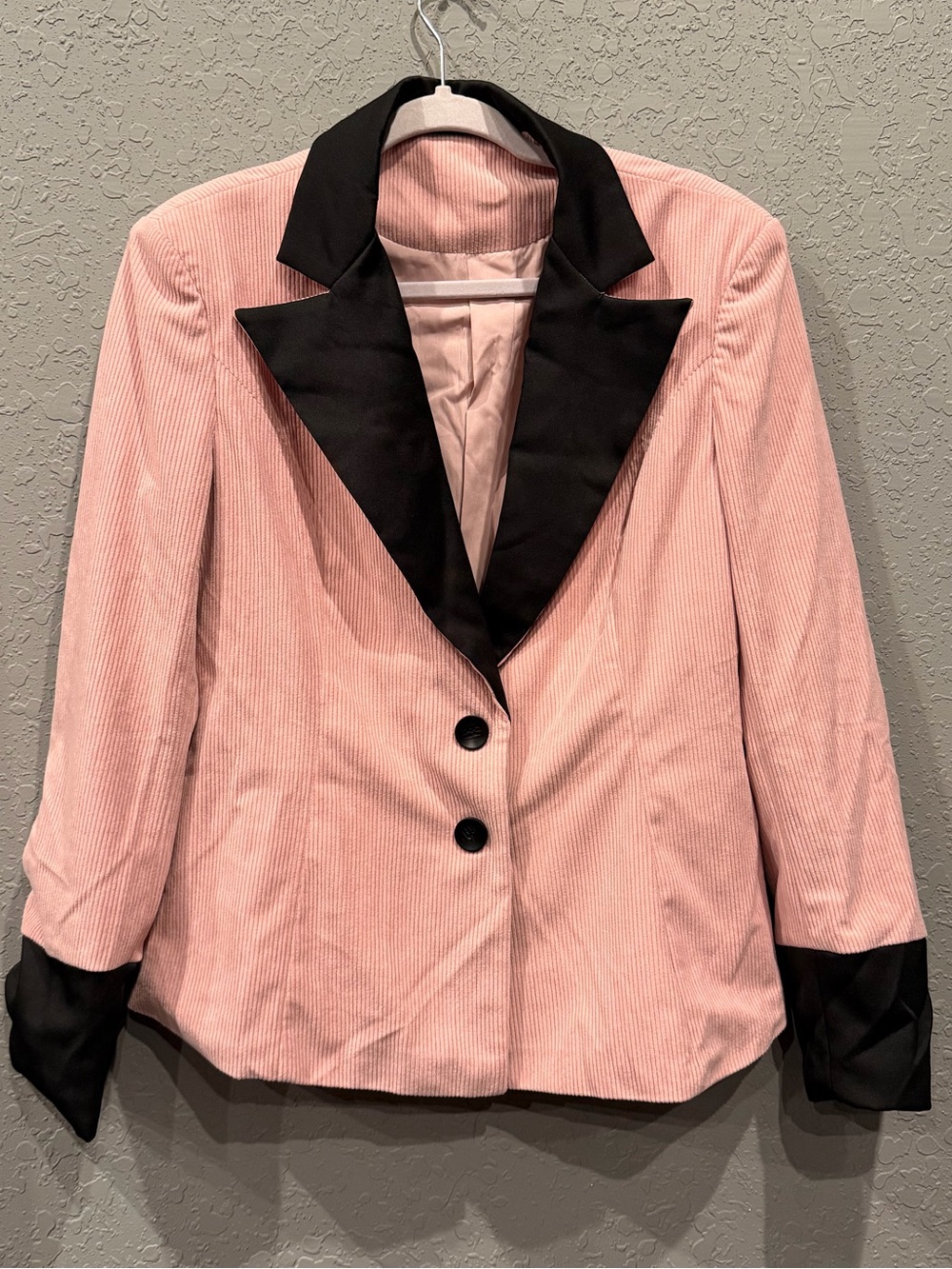 pink corduroy blazer with black lapel and black cuffs
